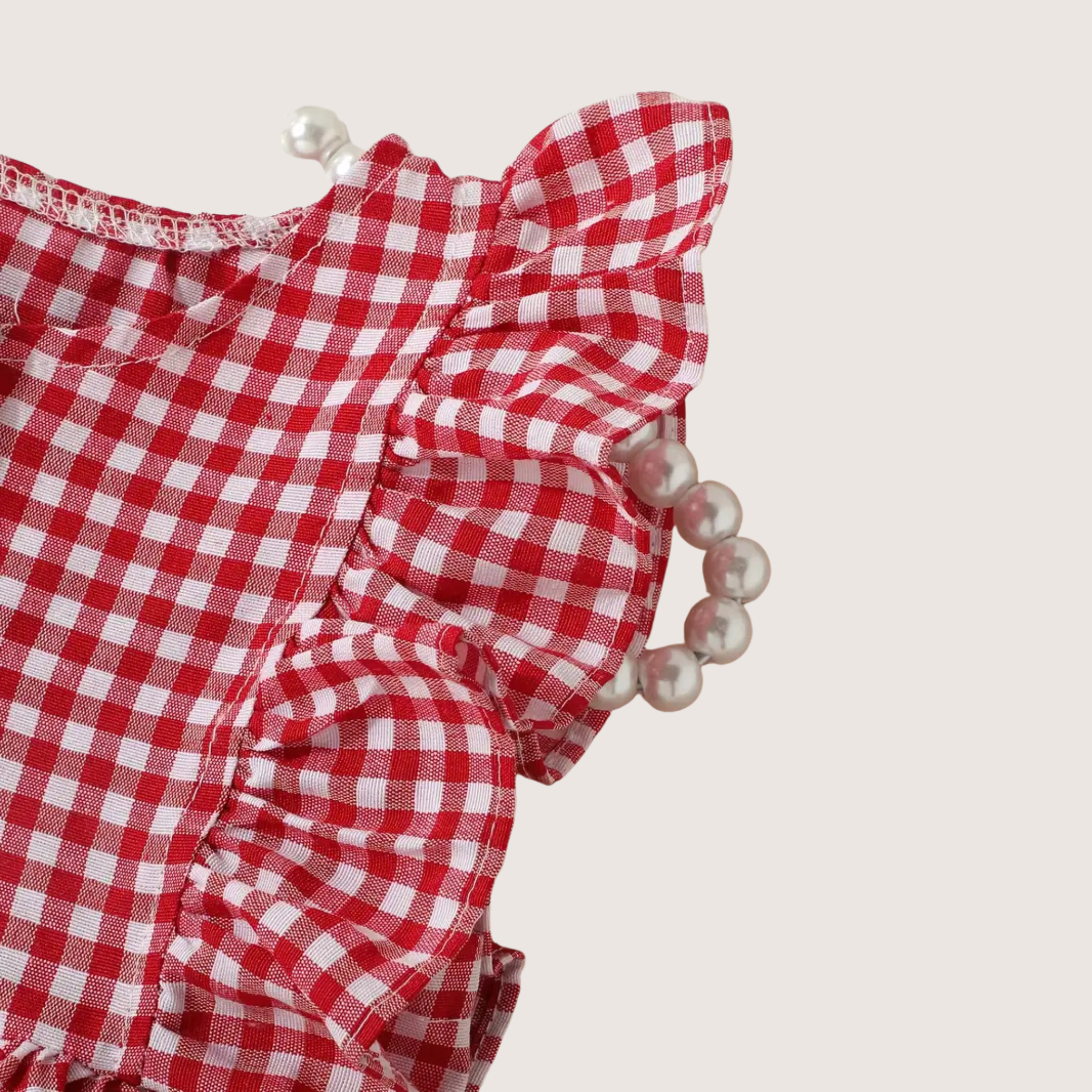 Baby romper with red vichy check, close-up of ruffle details