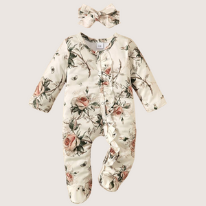 Baby girl floral romper set with ruffles and headband.