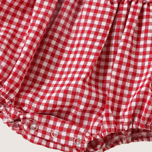 Snap closure at bottom of gingham baby romper