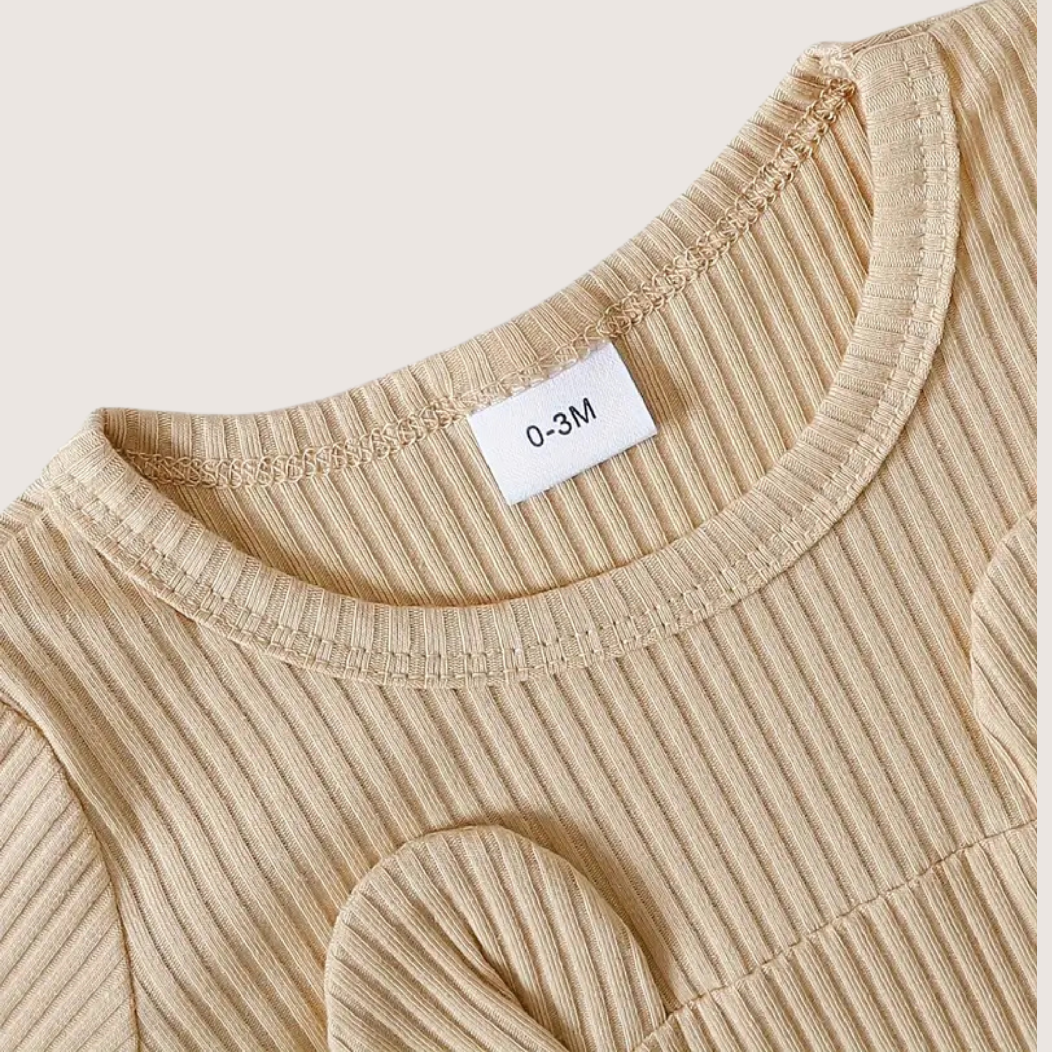 Close-up of soft ribbed cotton fabric on baby bear romper