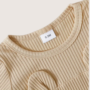 Close-up of soft ribbed cotton fabric on baby bear romper