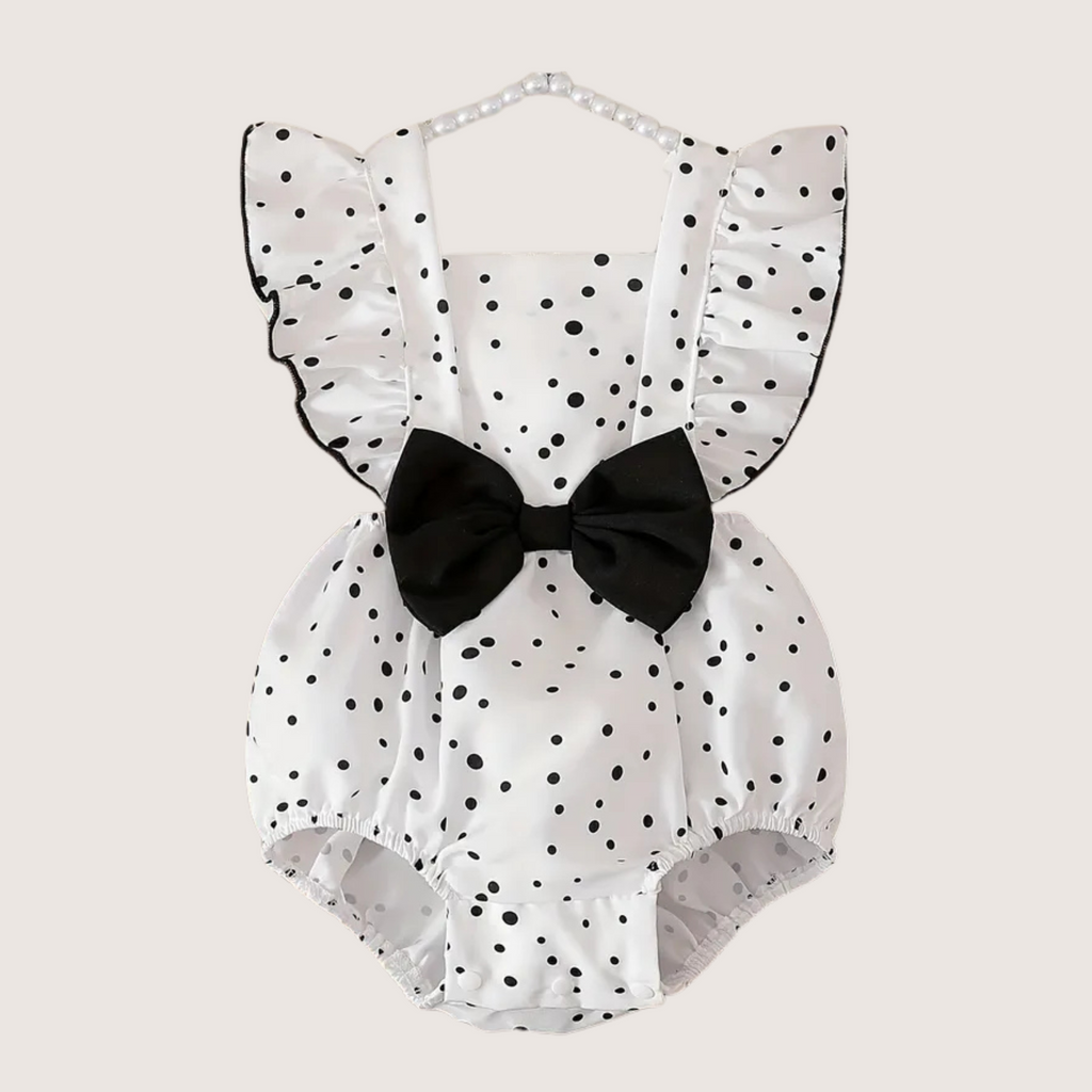 Baby girl white romper with black polka dots and bow, front view