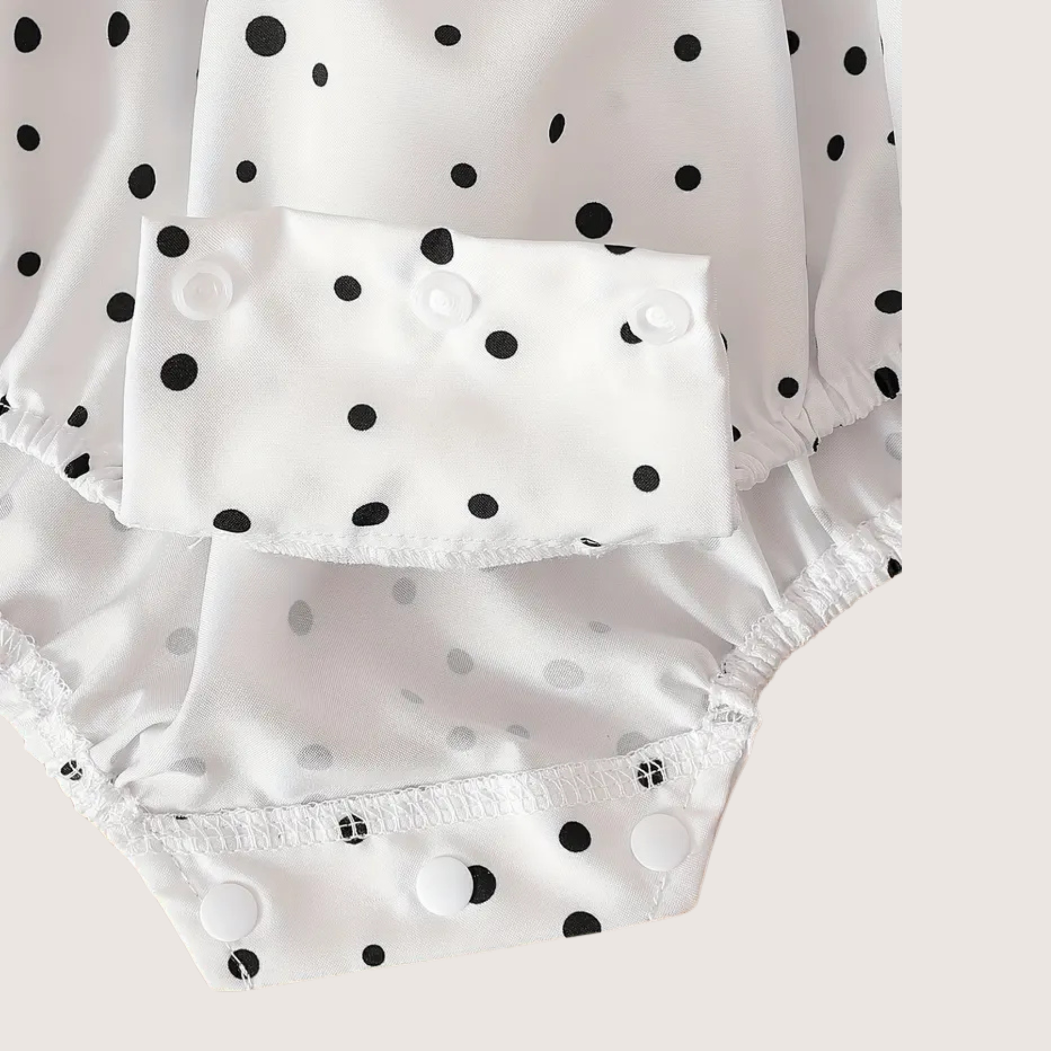 Soft lightweight fabric with black polka dot print for baby romper
