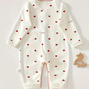 Back view of newborn one-piece with red heart print and “love” detail