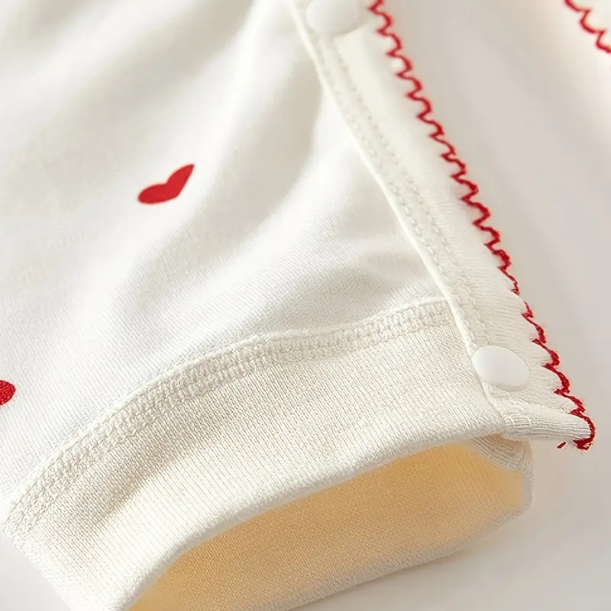 baby-one-piece-red-stitching-detail