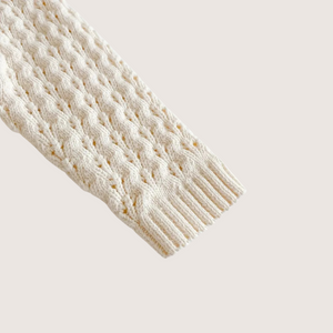 Close-up of knit texture on baby jumpsuit sleeve