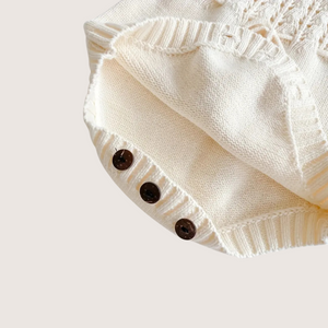 Knit baby jumpsuit with wooden buttons and adjustable straps