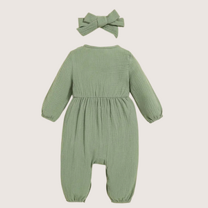 Back view of olive green baby girl romper with bow headband